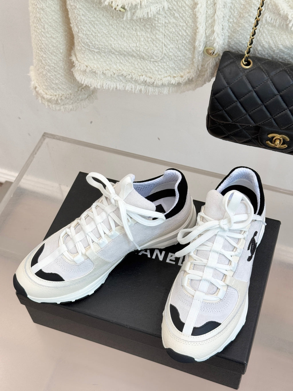 Chanel lace-up sneakers in white with black side panels and chunky sole