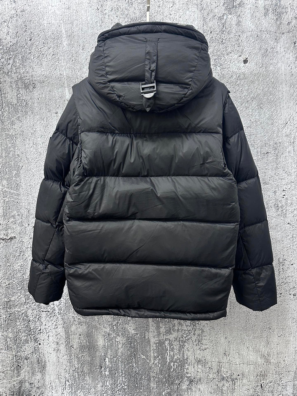 Long quilted puffer jacket with hood and back panel stitching, dark color