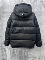 Long quilted puffer jacket with hood and back panel stitching, dark color