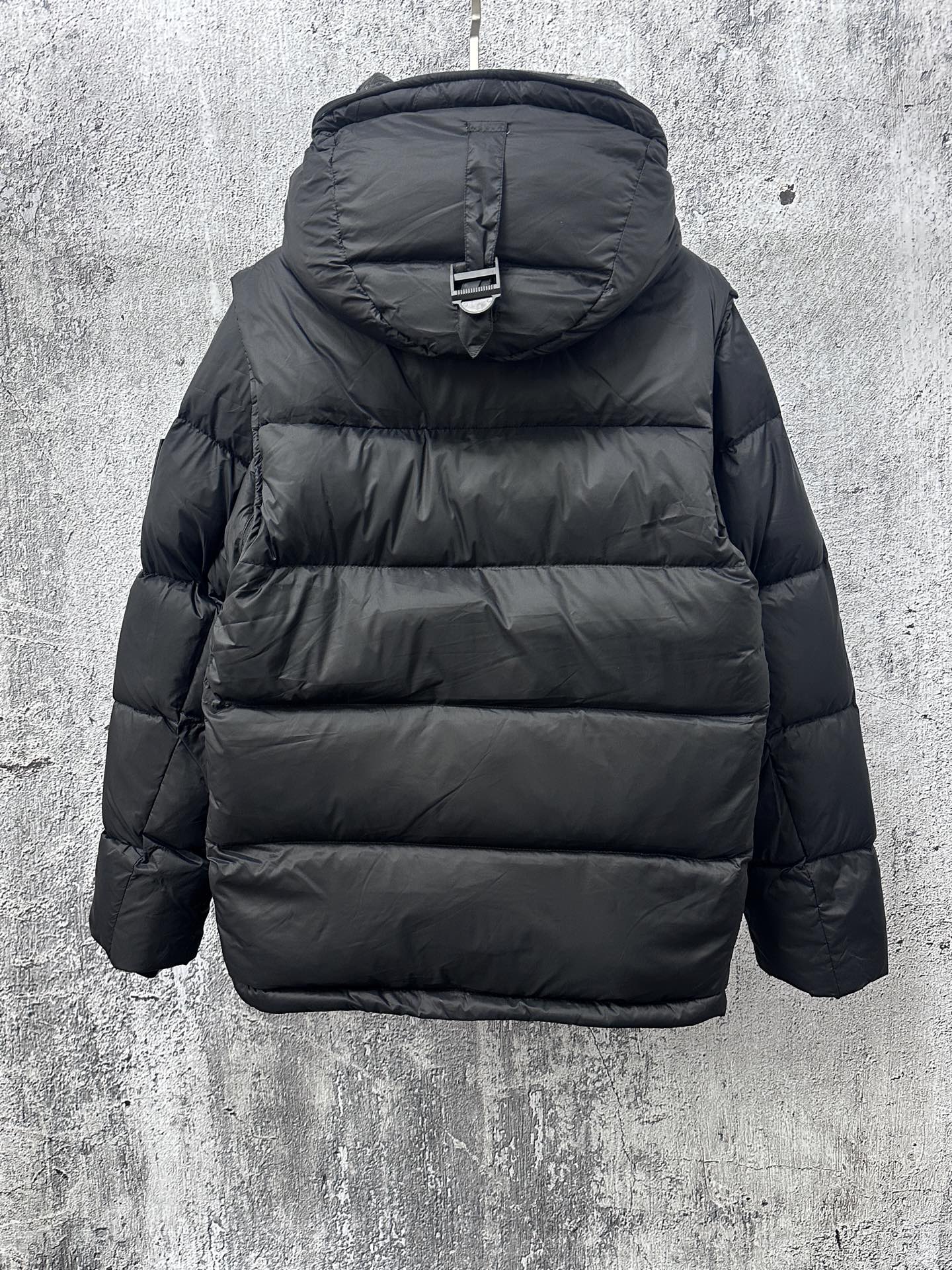 Long quilted puffer jacket with hood and back panel stitching, dark color