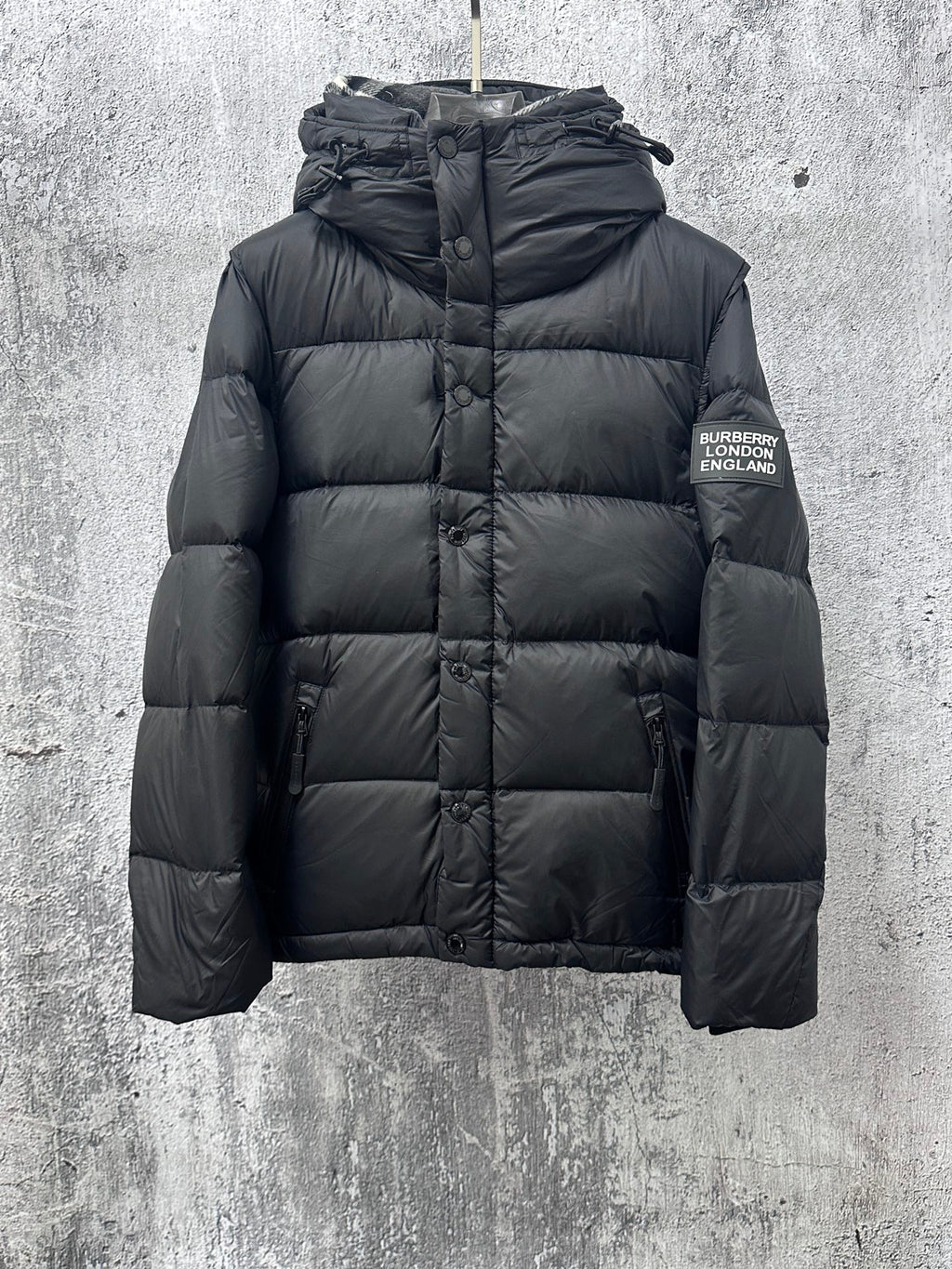 Long quilted puffer jacket with hood, front zipper, and Burberry England logo patch