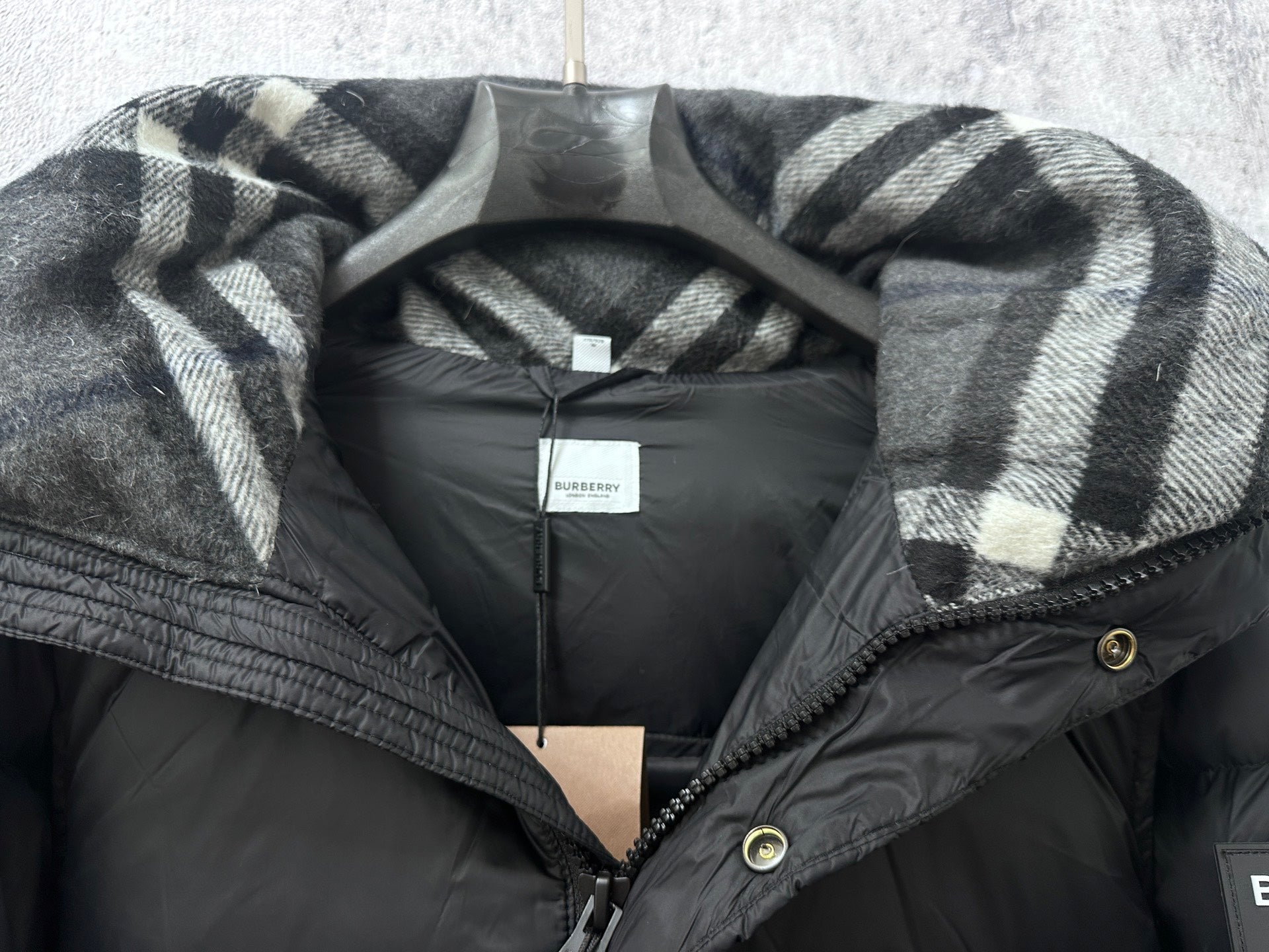 Long puffer jacket with plaid-lined hood and inner neck label