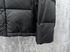 Long puffer jacket side view with zipper, buttons, and dark front pocket