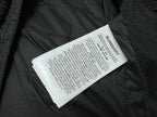 Long puffer jacket interior with Burberry care label on dark fabric