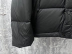 Long puffer jacket sleeve and hem with quilting and button cuff detail