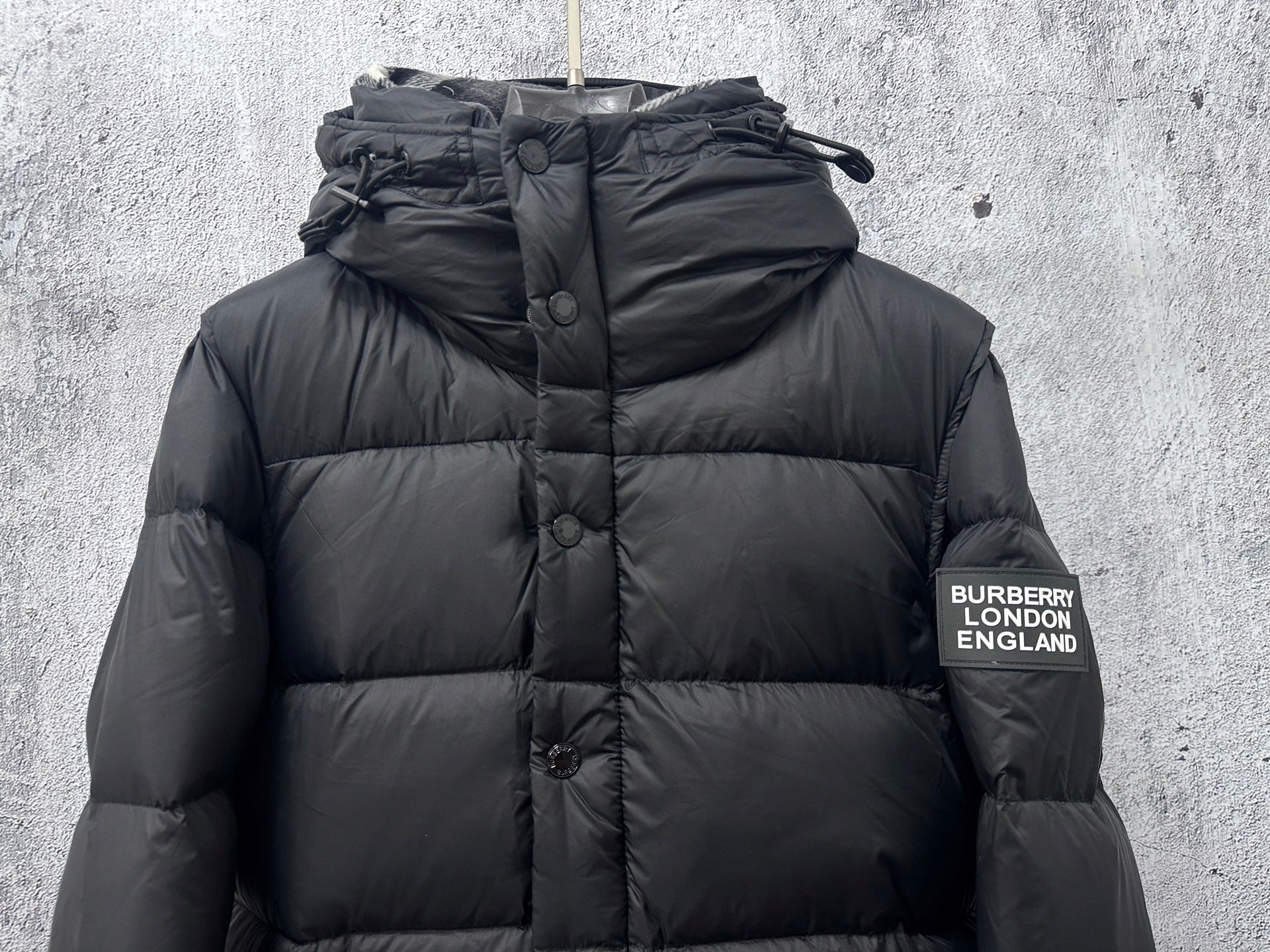 Long quilted puffer jacket with hood, front buttons, and Burberry London England patch