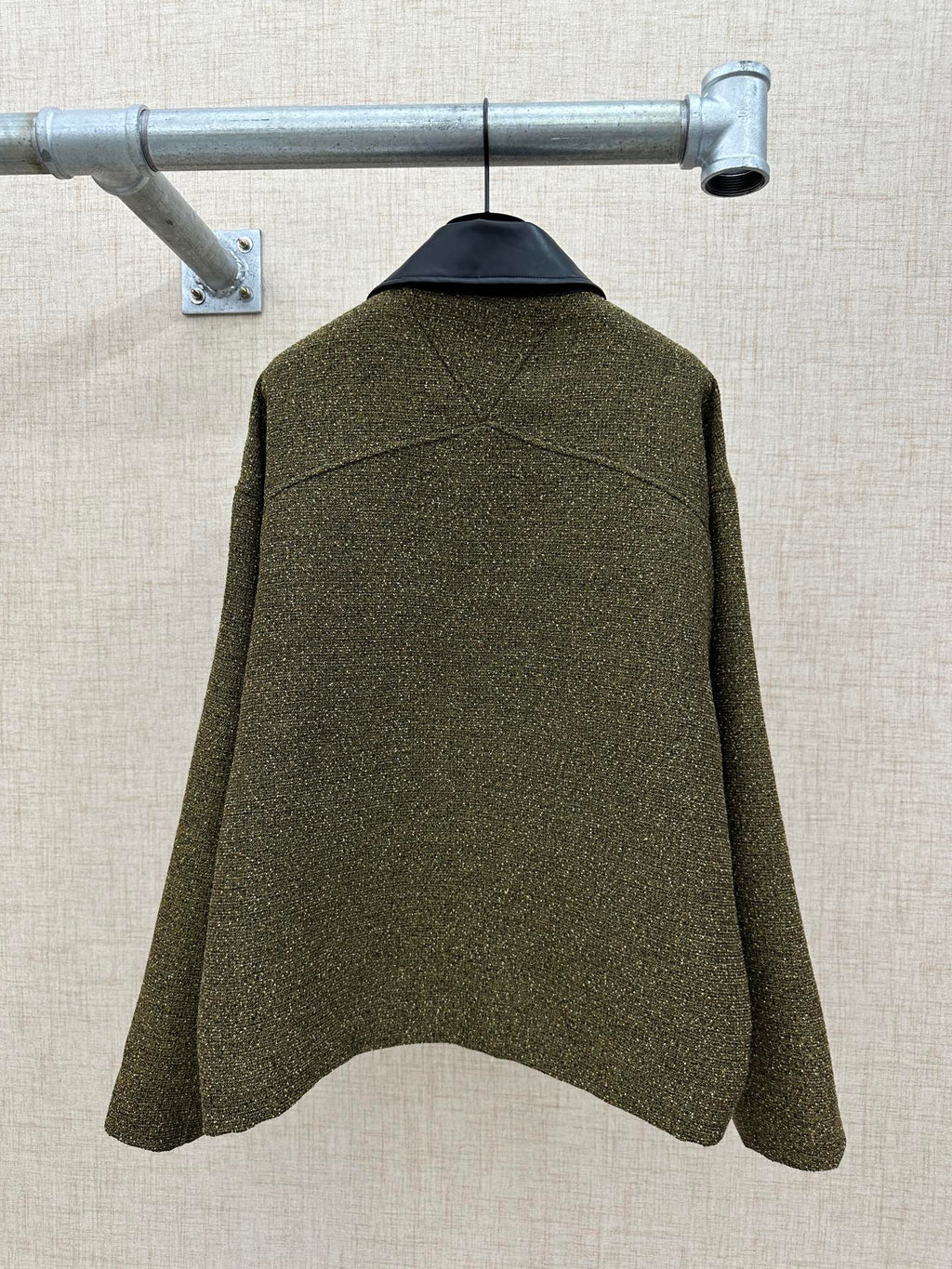 Olive textured jacket back view with structured shoulders and center back seam