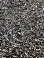Close-up of olive and dark speckled woven fabric texture