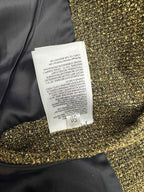 Dark jacket with gold sequin cuff trim and care label
