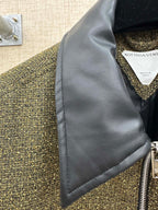 Dark blue inner collar panel and front zipper on olive textured jacket