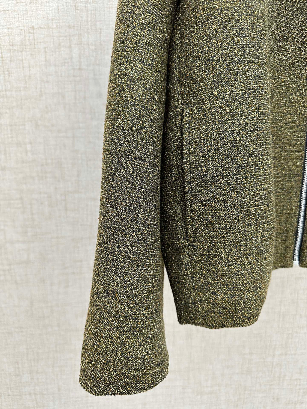 Olive textured jacket sleeve and hem with flared cuff shape