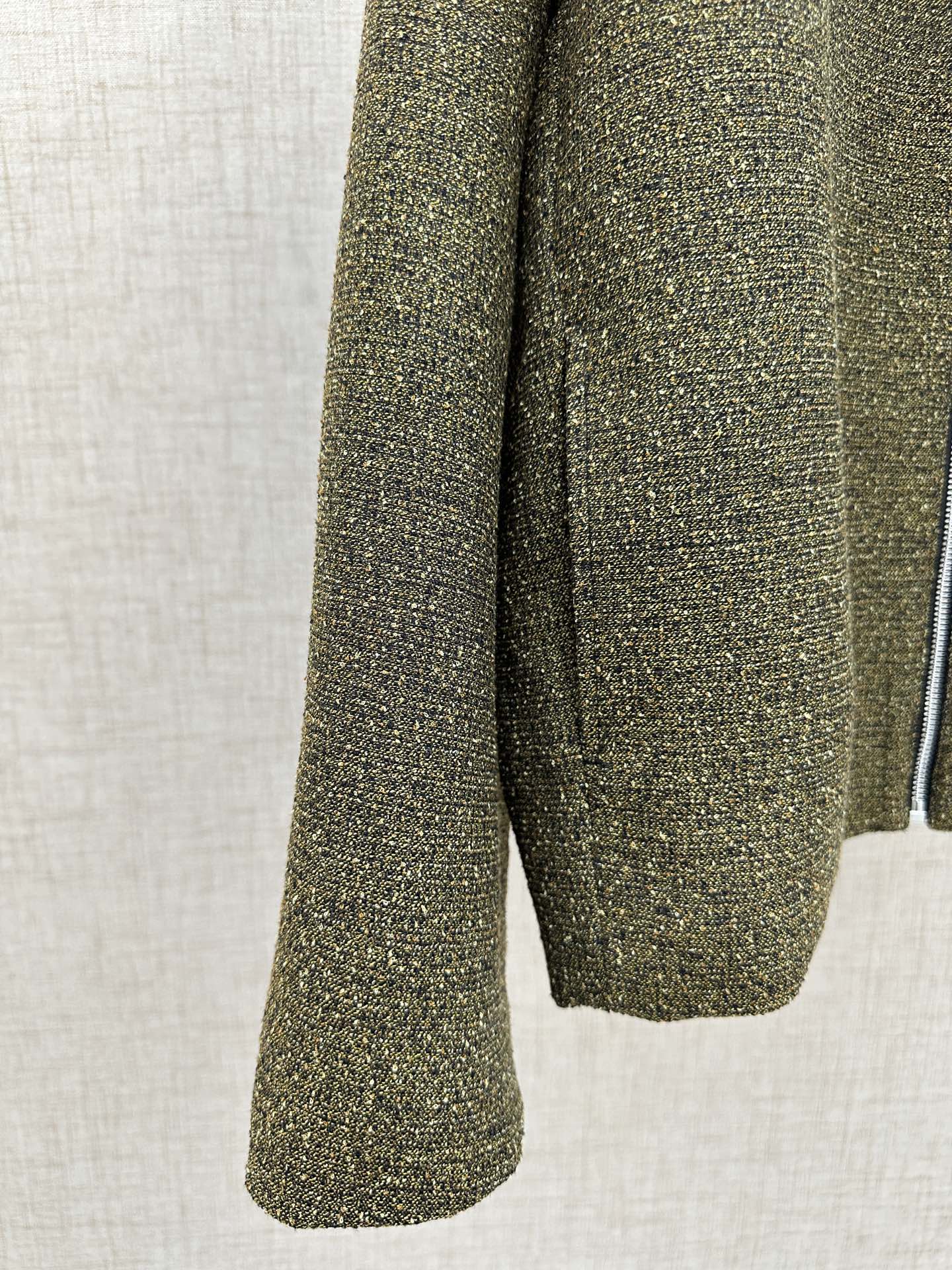 Olive textured jacket sleeve and hem with flared cuff shape