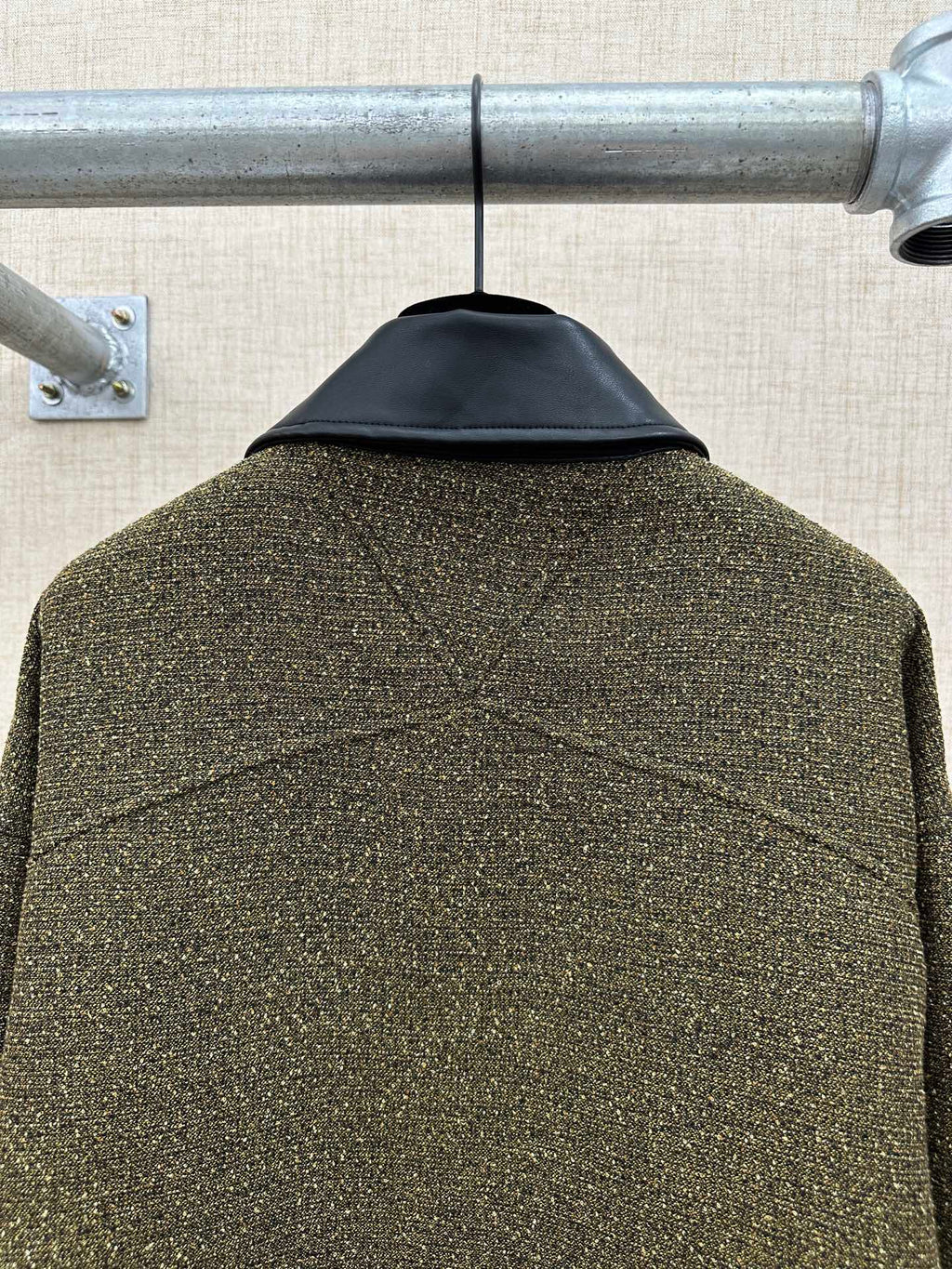 Olive textured jacket back with stitched yoke seam and center back drape