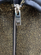 Front zipper pull and logo tag on olive textured jacket