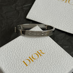 Silver-tone cuff bracelet with Christian Dior engraving on wide band
