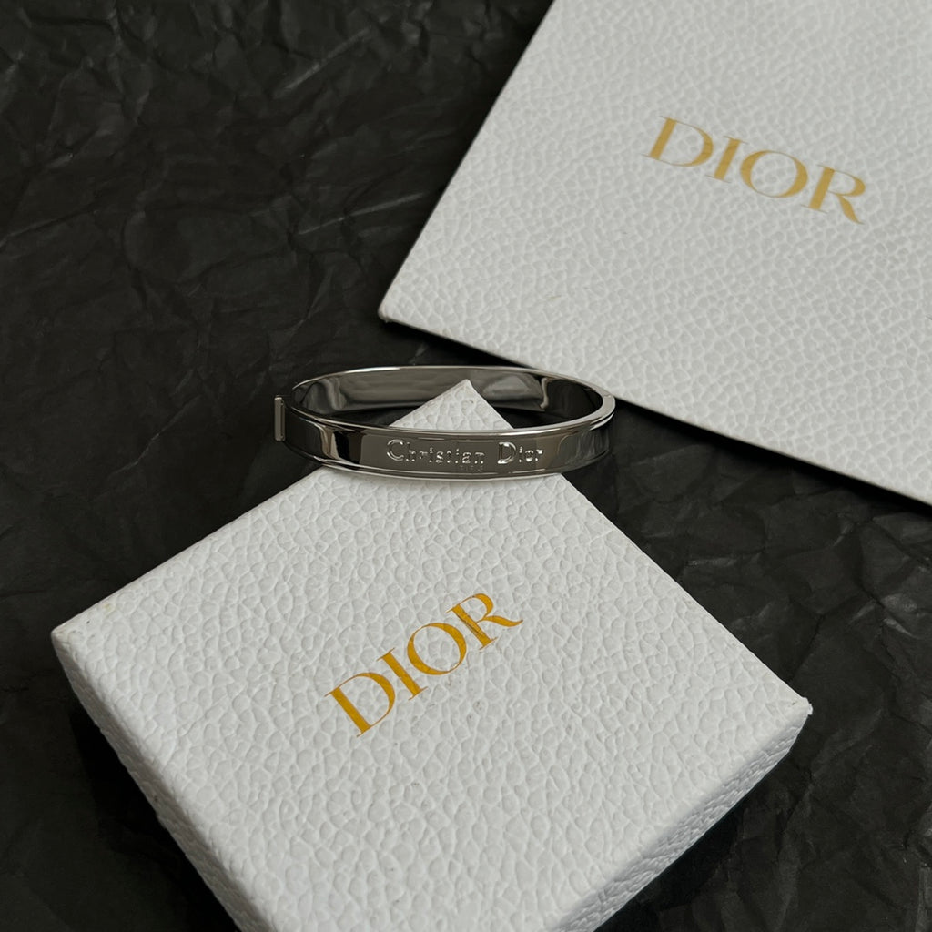 Silver-tone cuff bracelet with engraved Christian Dior logo