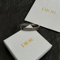 Silver-tone cuff bracelet with engraved Christian Dior logo