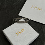 Silver-tone cuff bracelet with engraved Christian Dior logo