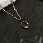 Gold-tone Dior charm necklace with black heart pendant and R charm on chain