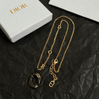 Gold-tone Dior charm necklace set with black heart pendants and round O accents