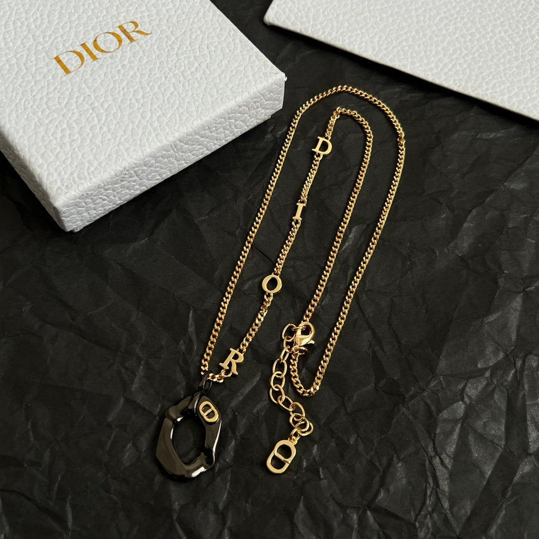 Gold-tone Dior charm necklace set with black heart pendants and round O accents