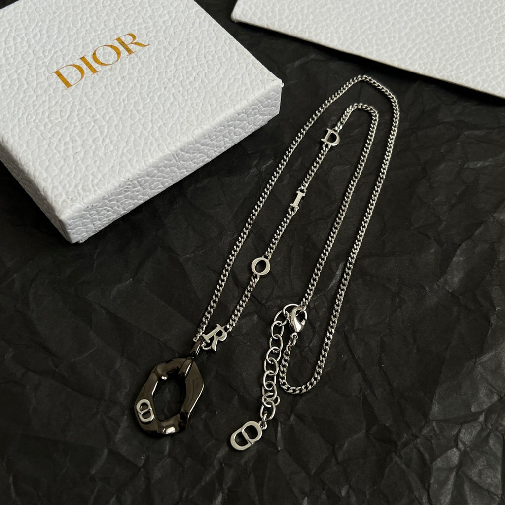 Dior charm necklaces with multiple silver-tone chains and black enamel charm pendants