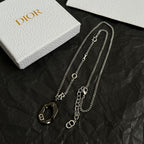 Dior charm necklaces with multiple silver-tone chains and black enamel charm pendants
