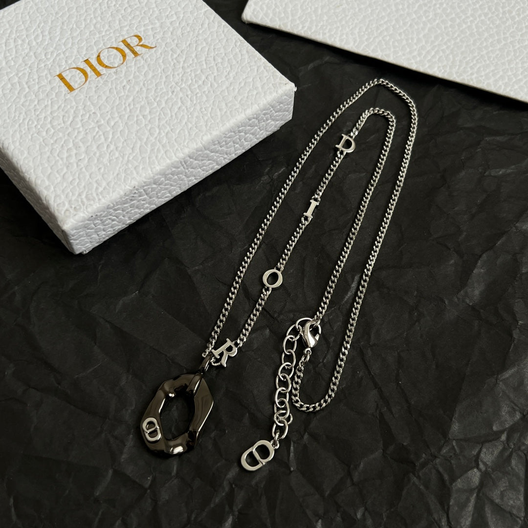 Dior charm necklaces with multiple silver-tone chains and black enamel charm pendants