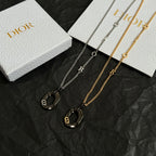 Dior layered necklaces with three black heart pendants and gold and silver chains