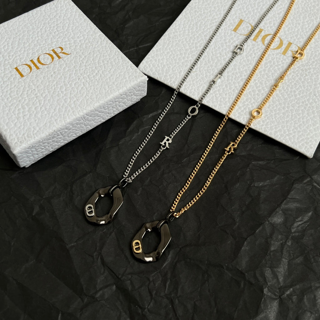 Dior charm necklaces with black enamel oval charms on silver and gold chains