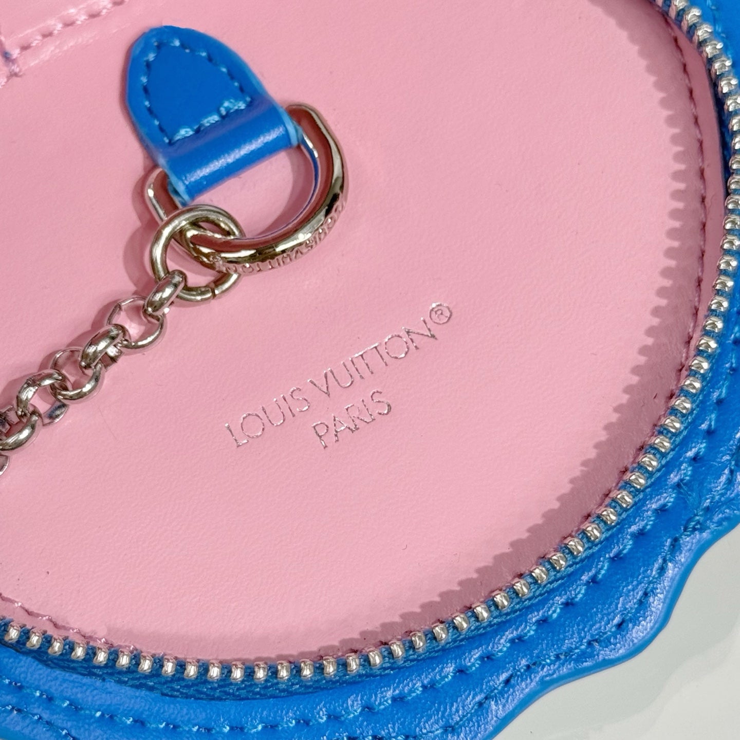 Louis Vuitton key pouch close-up, pink interior with logo print