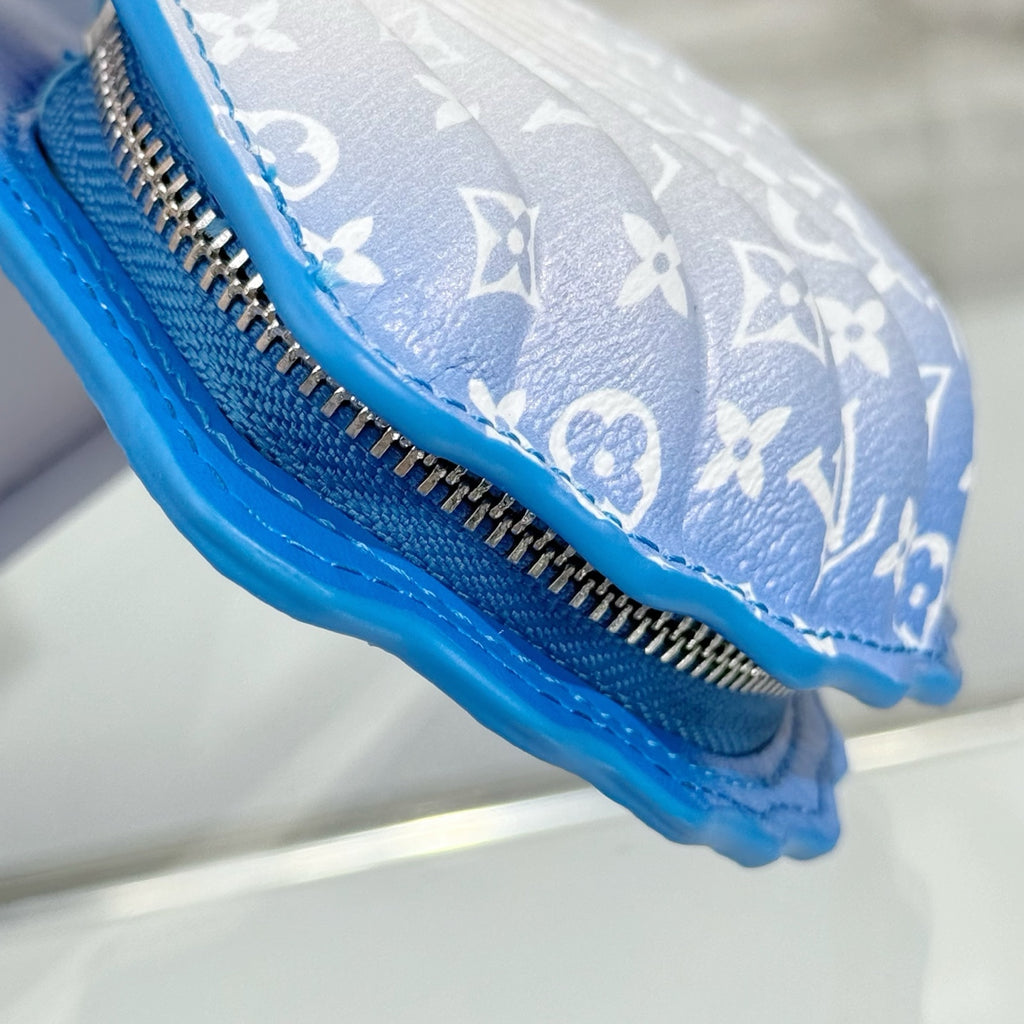 Small monogram pouch bag side view with zipper track and blue textured trim