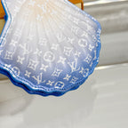 Small monogram pouch bag with blue border and light monogram pattern, rounded bottom