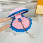 Louis Vuitton small shell bag interior view, pink lining with blue zipper and silver chain