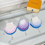 Louis Vuitton scallop mini pouch set: pink, purple, and light blue with keyring.