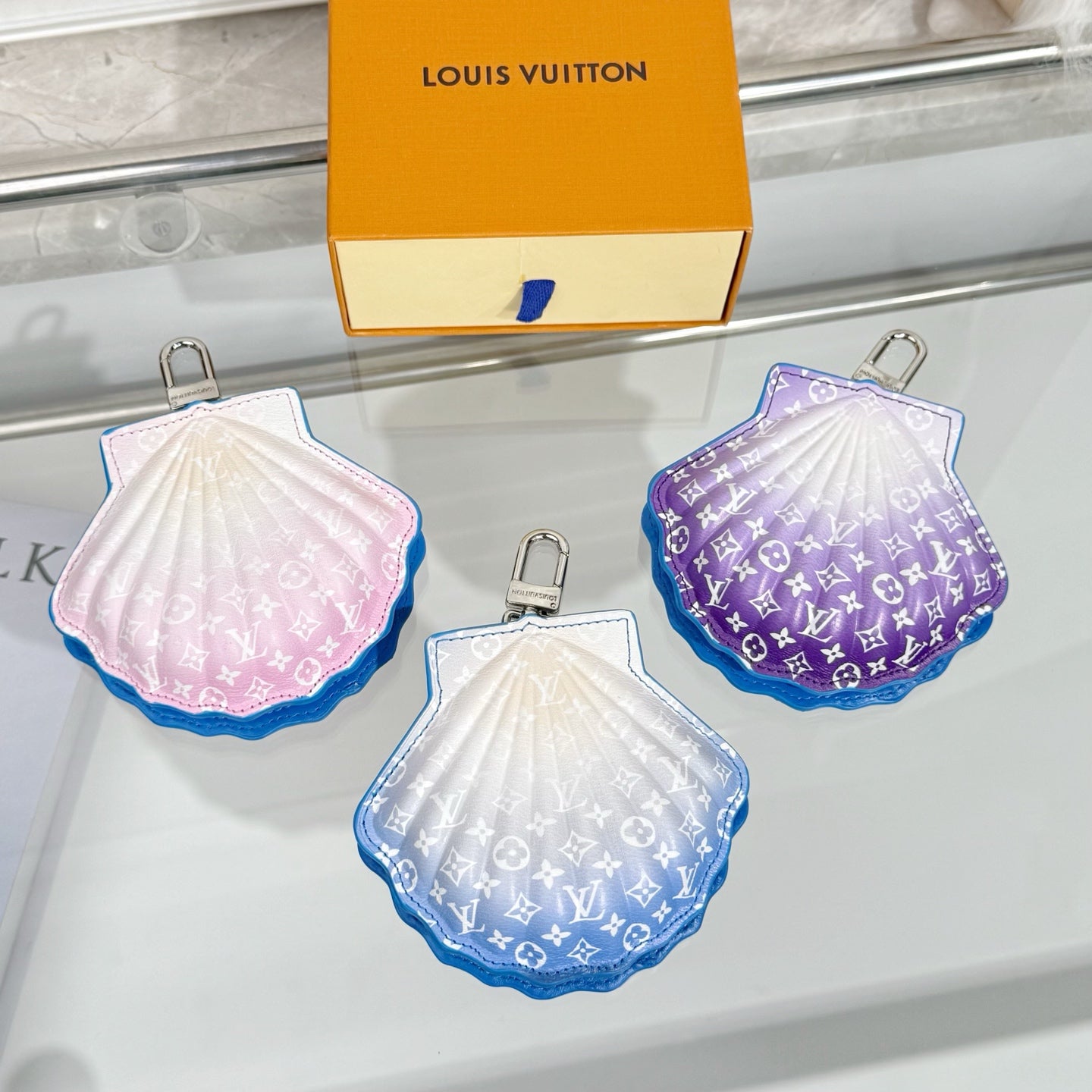 Louis Vuitton small shell bags, white, pink, and purple monograms with blue key rings