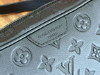 Louis Vuitton monogram embossed leather panel with decorative flower and logo details.