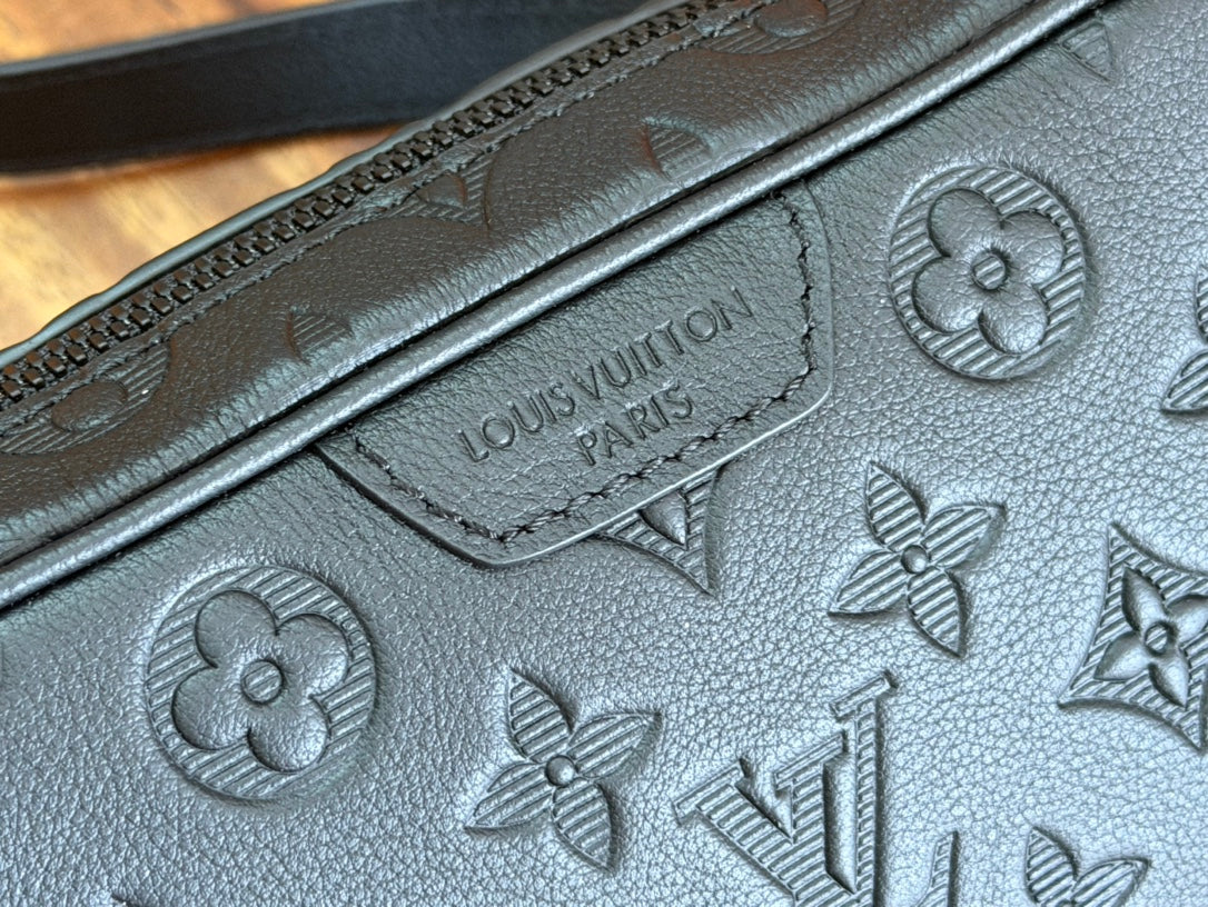Louis Vuitton monogram embossed leather panel with decorative flower and logo details.
