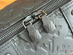 Louis Vuitton bag zipper track with embossed monogram motifs and metal zipper tabs.