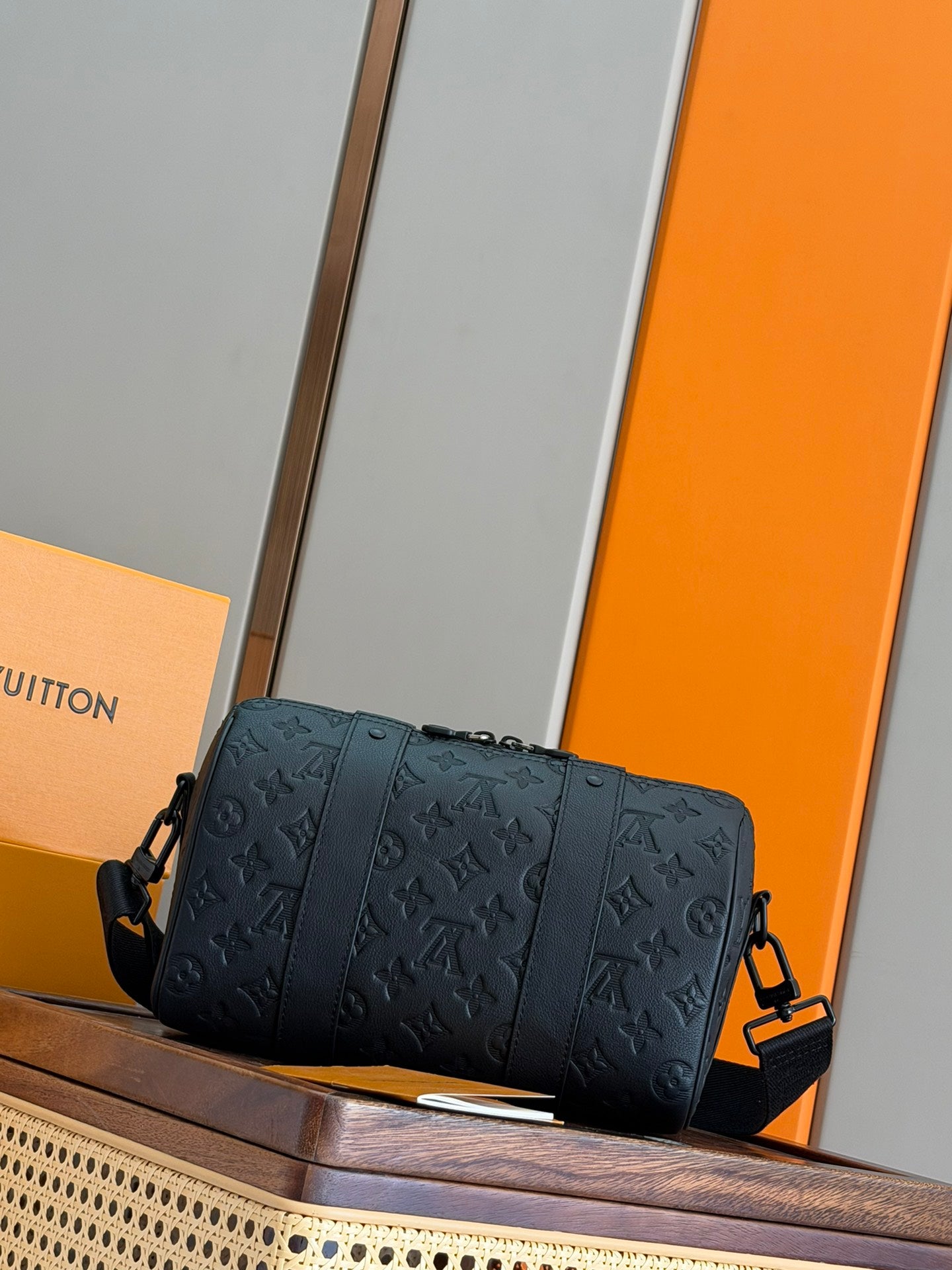Men's Louis Vuitton crossbody bag in dark blue with embossed monogram, front panel seams.