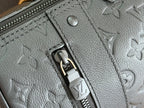 Louis Vuitton bag zipper detail with embossed monogram puller on textured leather.