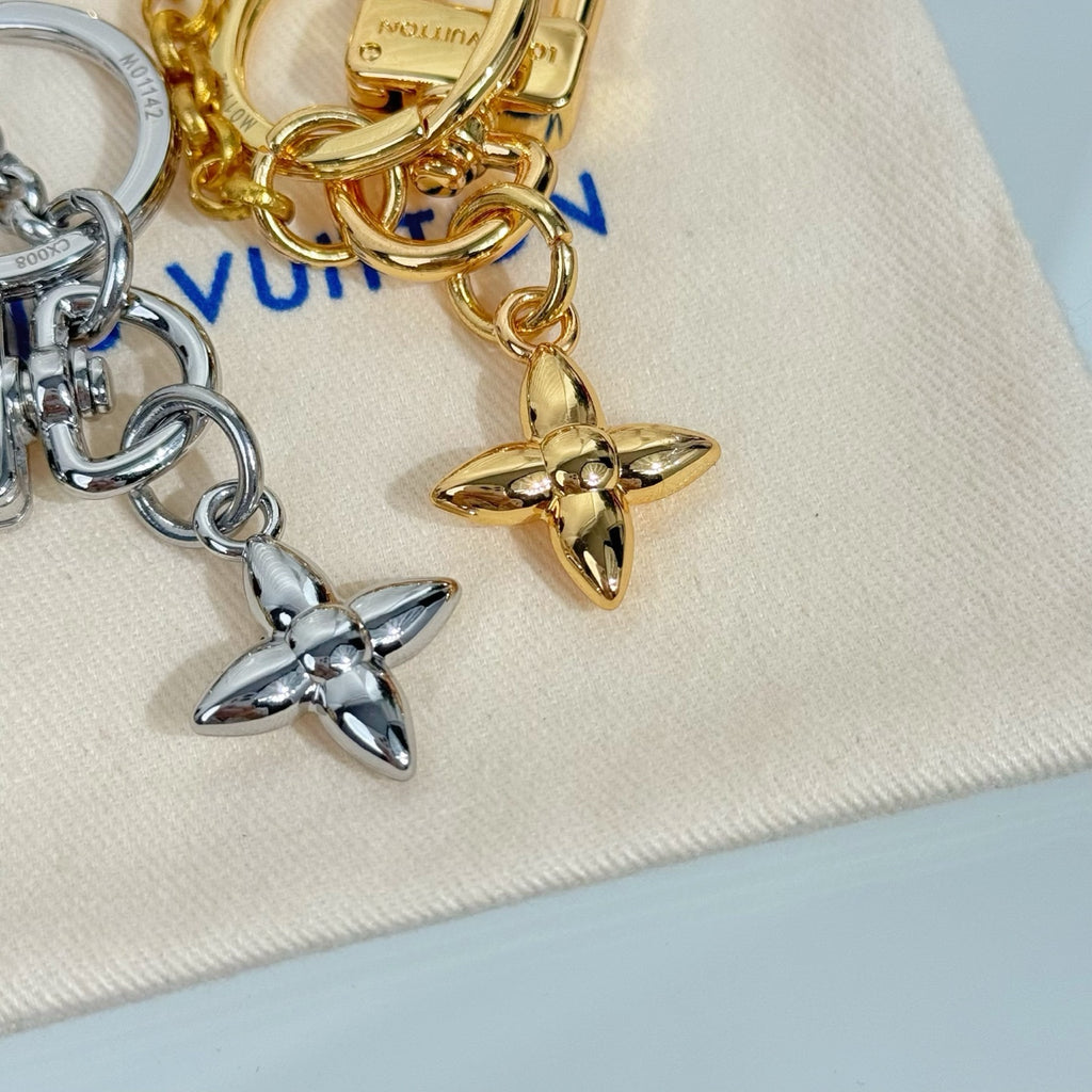 Louis Vuitton small bag charm keychain with star and heart charms in gold and silver