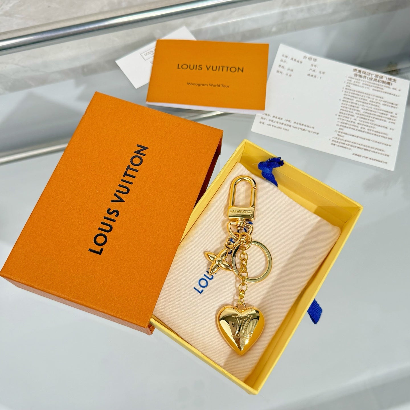 Louis Vuitton small bag charm keychain with gold lock and heart charm