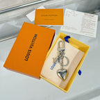 Louis Vuitton small bag charm keychain with silver heart pendant and gold lock