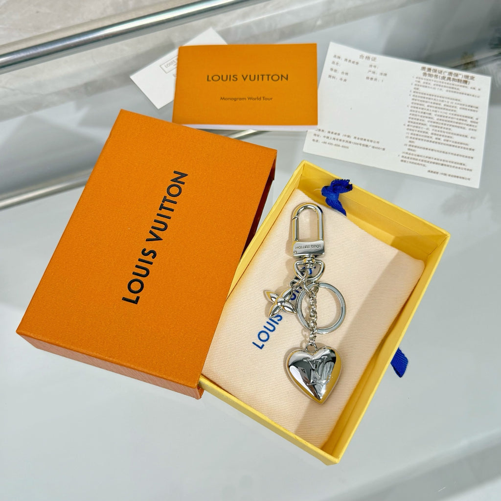Silver heart charm keychain in gift box with papers and ribbon