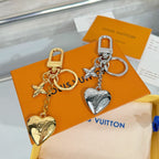 Louis Vuitton charm keychain set: gold & silver heart charms with star accents