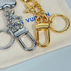 Louis Vuitton small bag charm keychain with gold lock, chain links, and silver heart