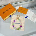 Beaded Louis Vuitton charm bracelet on pouch with gold ring and colorful beads