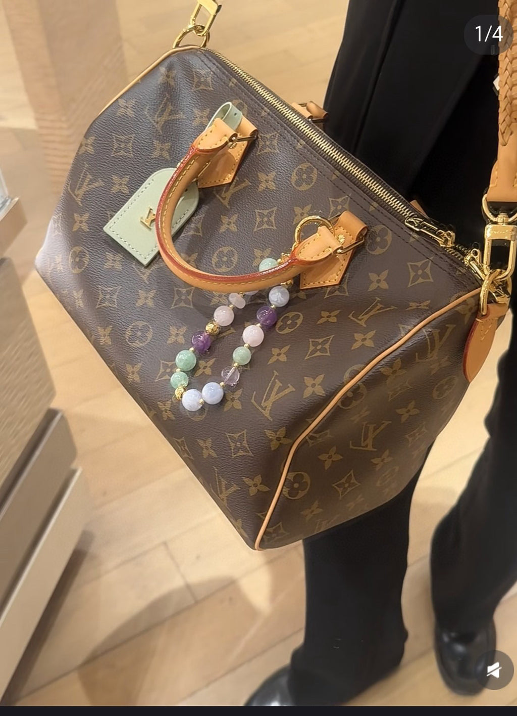 Louis Vuitton monogram small handbag with tan handle, hanging beaded charm, and tag