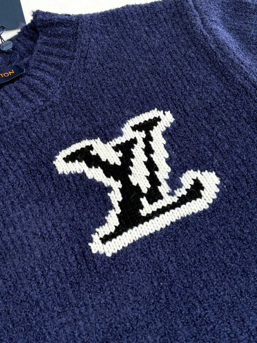 Louis Vuitton knit sweater with large white LV logo on dark blue chest